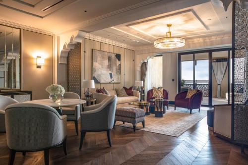 a living room filled with furniture and a large window at Jumeirah Mina A'Salam in Dubai
