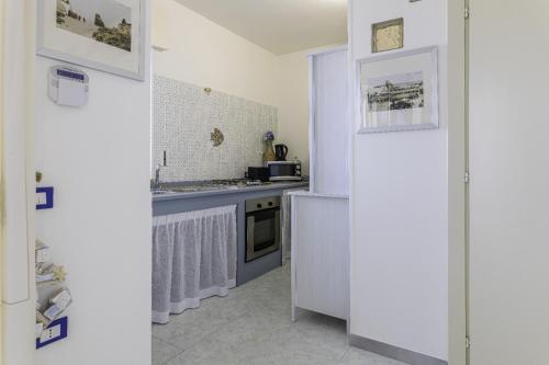 a kitchen with a sink and a stove at Andrew'S home - Playita in Torre Pali 