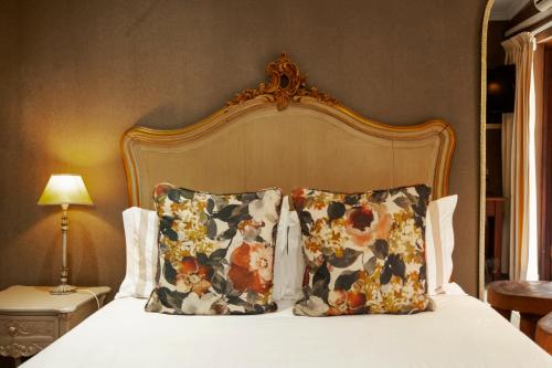 a bedroom with a bed with two pillows and a headboard at Town and Country Mpumalanga in Middelburg