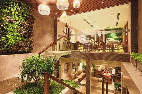 an open lobby with plants and a dining area at CHERRY BOUTIQUE HOTEL in Ho Chi Minh City