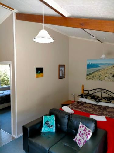 a living room with a couch and a bed at Arthur's Pass Alpine Motel in Arthur's Pass