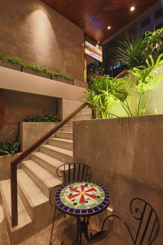 a table and chairs sitting next to a staircase at CHERRY BOUTIQUE HOTEL in Ho Chi Minh City