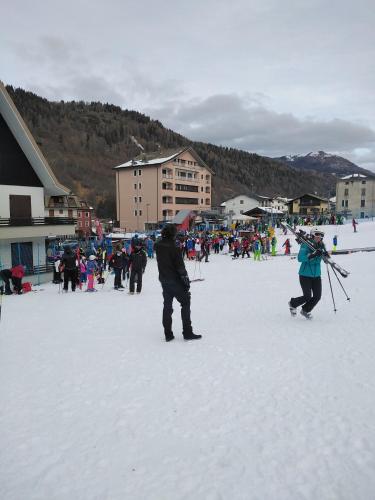 a group of people standing in the snow at BERTUZZI HOMES "Luxury Chalet" in Aprica