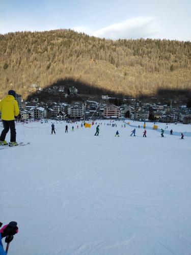 a group of people skiing down a snow covered slope at BERTUZZI HOMES "Luxury Chalet" in Aprica