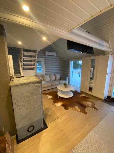a living room with a couch and a table at Villa Muikkupolku in Kokkola