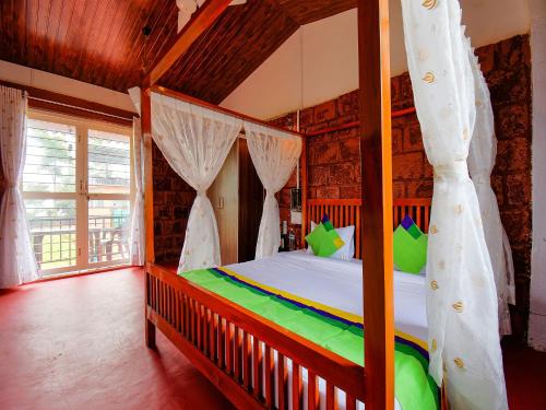 a bedroom with a canopy bed in a room at Treebo The Appa'S Resort in Mahabaleshwar