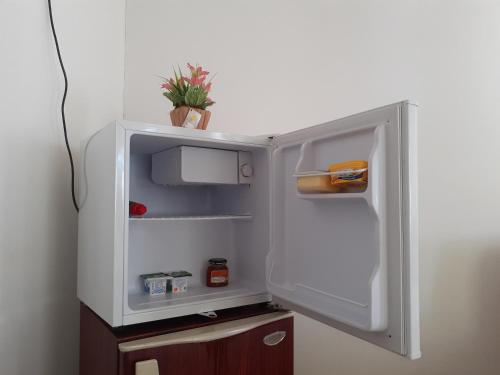 an open refrigerator door with a plant inside of it at Ann Villa Negombo in Negombo