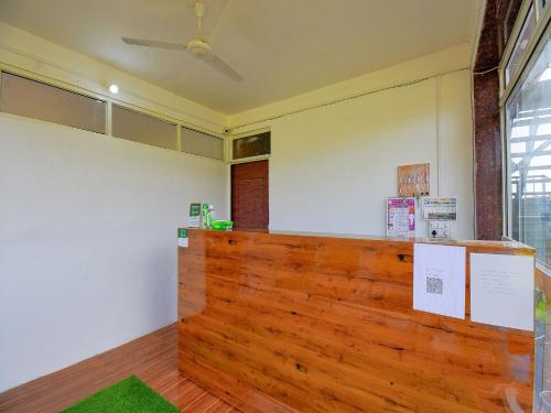 a restaurant with a wooden counter in a room at Treebo The Appa'S Resort in Mahabaleshwar