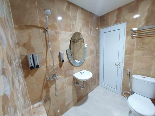 a bathroom with a toilet and a sink and a shower at Rons City Hotel near Simpang Lima Semarang Mitra RedDoorz in Semarang