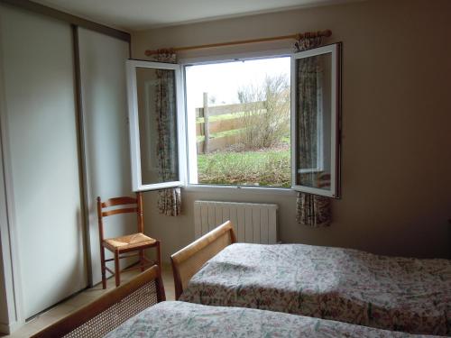 a bedroom with two beds and a window at Le Pit in Lessac