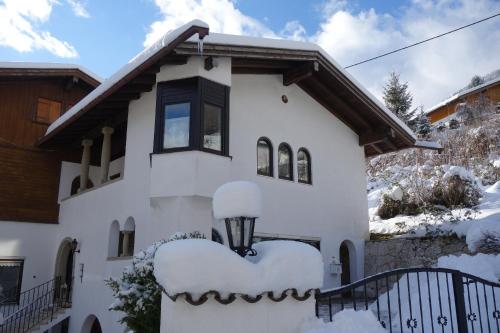 a white house with snow on it at Ferienwohnung Hergesell in Marktschellenberg