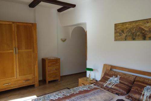 a bedroom with a bed and a wooden cabinet at Ferienwohnung Hergesell in Marktschellenberg