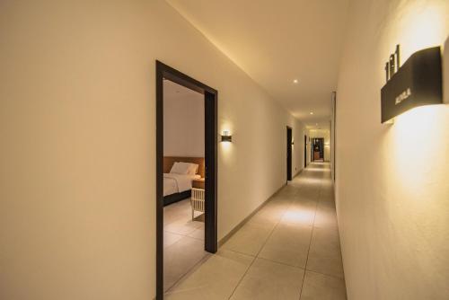 a hallway leading to a bedroom with a mirror at Alivila in Muar