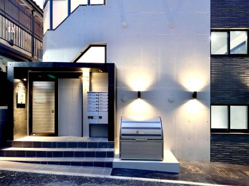 a house with stairs leading up to a door at Itos Ebisu in Tokyo