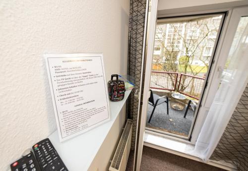 a mirror hanging on a wall next to a window at Hotel am Schlosspark Essen in Essen