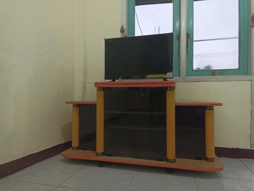 a tv on top of a table in a room at Hoya Residence Syariah in Sodong