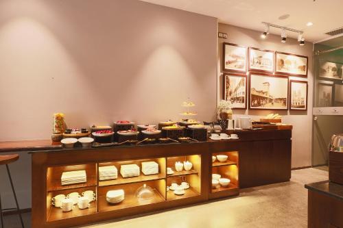 a display case in a store with many dishes at CHERRY BOUTIQUE HOTEL in Ho Chi Minh City