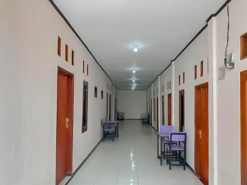 an empty hallway with chairs and tables in a building at RedDoorz @ Jalan Ahmad Yani in Karawang