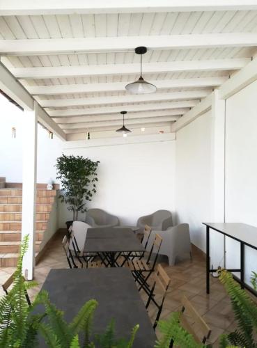 a patio with a table and chairs and a ceiling at Bianco Sale Trapani in Rilievo