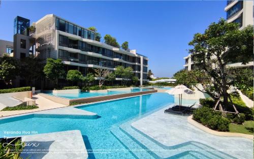 an image of a swimming pool in front of a building at VERANDA HUAHIN BY LUX in Hua Hin