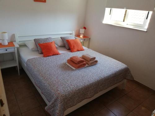 a bedroom with a bed with towels on it at Shell Bay Apartments in Korčula