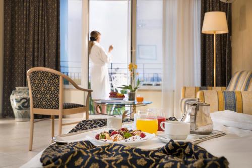 a hotel room with a table with a tray of food at Sant Alphio Garden Hotel & SPA in Giardini Naxos