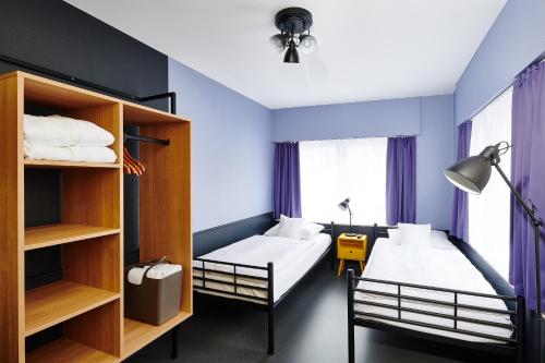 a small room with two beds and a couch at Hotel Zugbrücke Grenzau GmbH in Höhr-Grenzhausen
