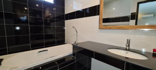 a bathroom with a sink and a mirror at The Room Boutique Hotel in Sakon Nakhon