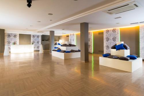 a room with couches and beds on display at Sant Alphio Garden Hotel & SPA in Giardini Naxos