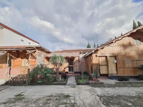 a house with a courtyard in front of it at Family Guest House Lembang RedPartner in Lembang