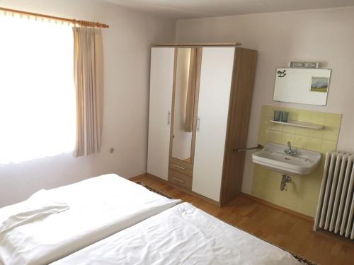 a bedroom with a bed and a sink at Schloss Fürstenstein in Berchtesgaden