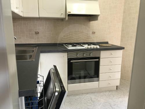 a kitchen with a stove and a counter top at Villa Due Mari By Cala Salento in Torre Lapillo