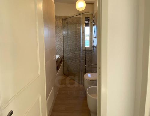 a bathroom with a toilet and a glass shower at Villa Due Mari By Cala Salento in Torre Lapillo