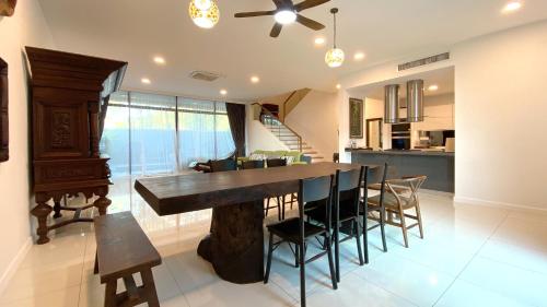 a kitchen and dining room with a table and chairs at LAVANYA Private Pool Villa Residence 2 Floors @ Pantai Cenang. in Pantai Cenang