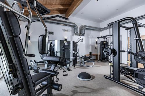 a gym with several treadmills and weights at Hotel Pirchnerhof in Reith im Alpbachtal