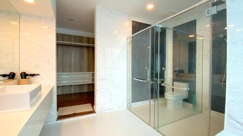 a bathroom with a glass shower and a sink at LAVANYA Private Pool Villa Residence 2 Floors @ Pantai Cenang. in Pantai Cenang