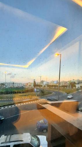 a view of a parking lot through a window at جولدن نيو جوان - Golden New Gewan - للشقق المخدومة in Abha