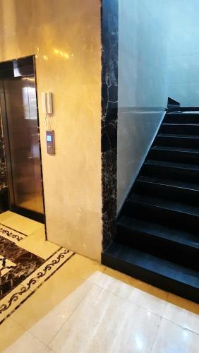 a staircase in a building with a escalator at جولدن نيو جوان - Golden New Gewan - للشقق المخدومة in Abha