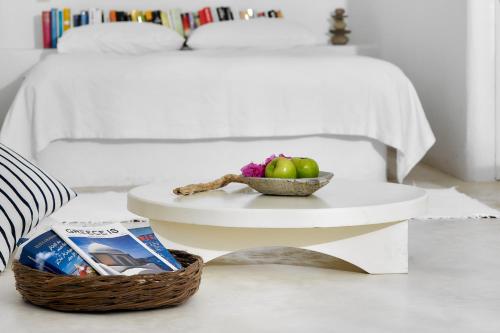 a table with a bowl of apples and a bowl of cereal at Finikia Memories Hotel in Oia