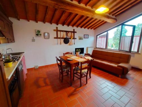 a living room with a table and a couch at San Lorenzo Agriturismo in Buonconvento
