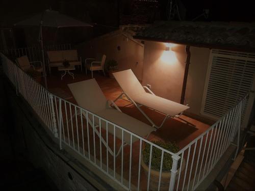 a room with two chairs and an umbrella at night at Portica10 Assisi in Assisi