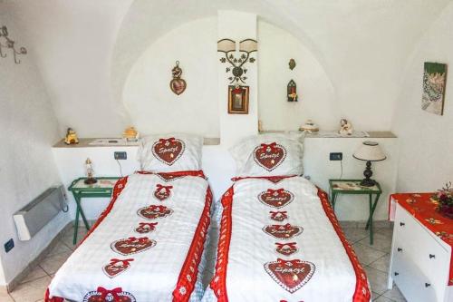 two beds in a room with two tables at CASA BERNARD Zortea VANOI cuore verde del Trentino in Canale San Bovo