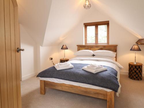 a bedroom with a large bed in a attic at The Clockhouse in Llandyssil