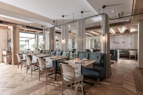 a dining room with long tables and chairs at Hotel Pirchnerhof in Reith im Alpbachtal