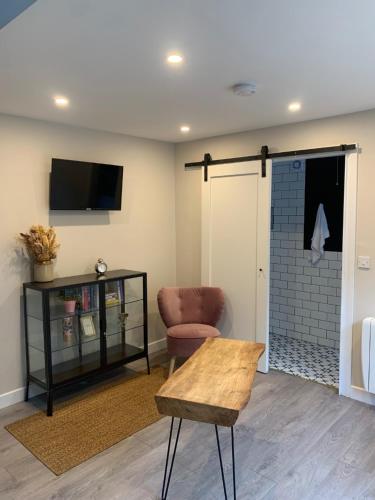 a living room with a chair and a sliding door at Stay Barrow Blueway - The Stables in Monasterevin
