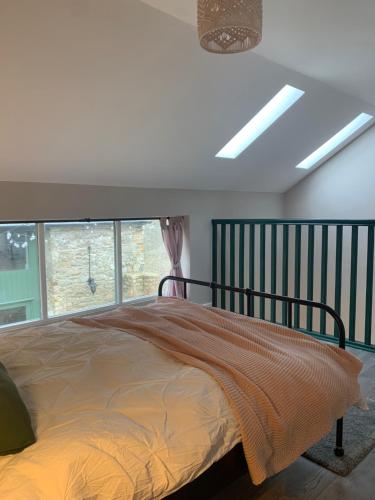a bedroom with a bed and a window at Stay Barrow Blueway - The Stables in Monasterevin