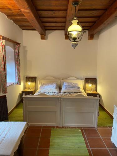 a bedroom with a bed in a room with wooden ceilings at Öregház 1839 in Csopak