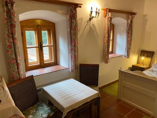 a bedroom with a table and a window and a bed at Öregház 1839 in Csopak