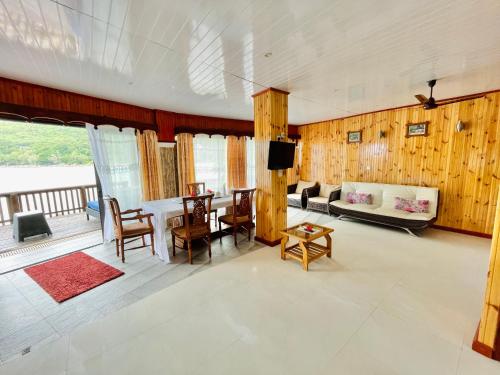 a living room with a table and a couch at Villa Chez Batista in Takamaka