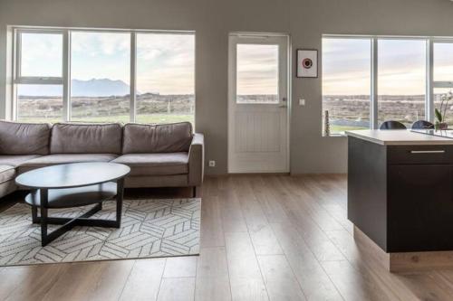 a living room with a couch and a table at Beautiful house in the nature of West Iceland in Borgarnes
